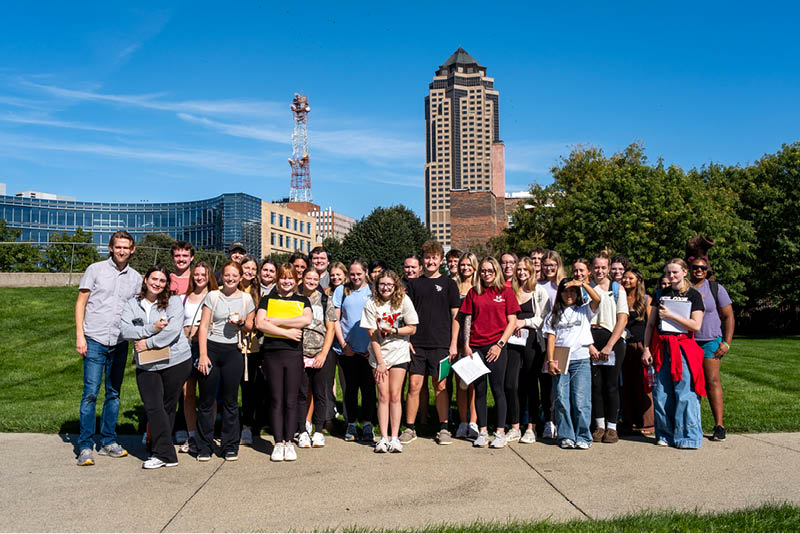 GV Honors Program group photo Members of the Fall 2026 cohort of the Grand View Honors Program, along with Honors Program Director KC McGinnis (left), pose for a picture at the Pappajohn Sculpture Park in Des Moines Iowa, during a field trip for the Logos: After Hours course.
